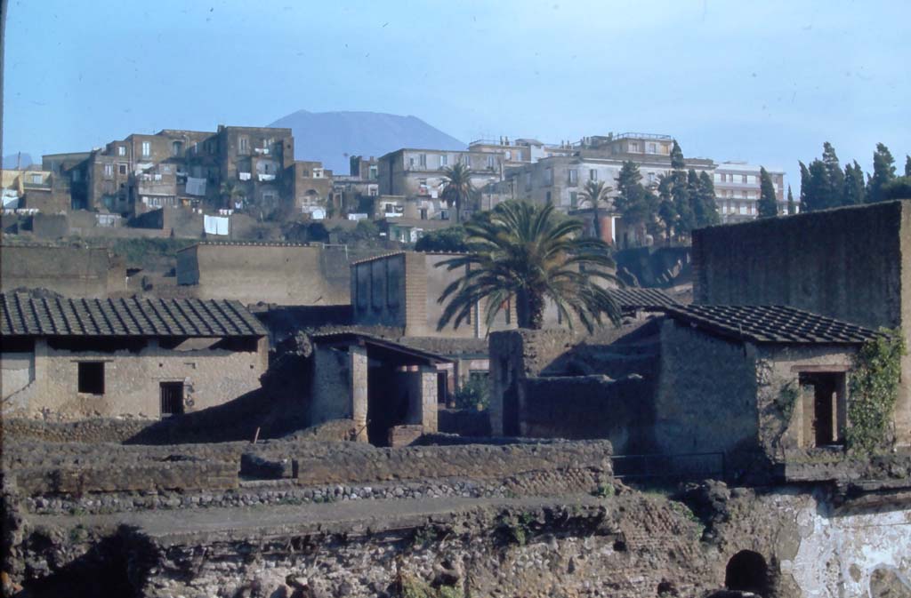 III, 19/18/1, Herculaneum. 4th December 1971.
Looking north-east from access roadway towards rooms on east side near doorway at III.19, on left and centre.
On the right is part of IV.1/2, House of Mosaic Atrium.
In the lower right is the south end of the arched gateway, which would have led to the beach from Cardo IV Inferiore.
Photo courtesy of Rick Bauer, from Dr George Fay’s slides collection.